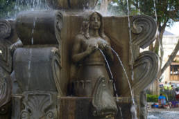Fountain in main square in Antigua, a woman holding her water giving breasts