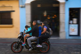 Family on small motorcycle in Antigua