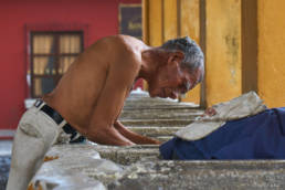 An old man using Tanque La Union to fresh up