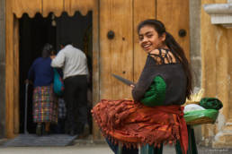 Girl selling fruits in front of church door in Antigua