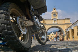 DR650 in front of Santa Catalina Arch and iglesia de la Merced in the background.
